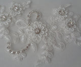 An ivory beaded rhinestones lace applique bridal wedding floral beads lace motif is for sale. Sold by per piece