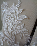 A piece of ivory sequined lace applique bridal wedding floral embroidered bolero lace motif is for sale. Sold by per piece
