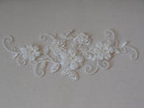 An ivory beaded floral lace applique / bridal wedding beaded floral tulle lace motif is for sale. Sold by per piece