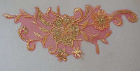 A gold sequined embroidered lace applique on red tulle / gold sequins lace motif is for sale. Sold by piece.
