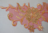 A gold sequined embroidered lace applique on red tulle / gold sequins lace motif is for sale. Sold by piece.