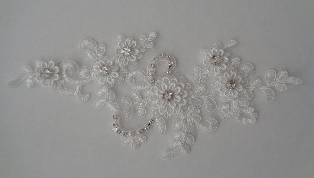An ivory beaded rhinestones lace applique bridal wedding floral beads lace motif is for sale. Sold by per piece