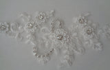 An ivory beaded rhinestones lace applique bridal wedding floral beads lace motif is for sale. Sold by per piece