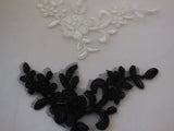 A Small piece of black or ivory lace applique / dress making floral lace motif